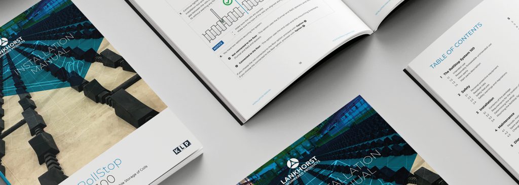 Open and closed installation guide manuals displayed on a desk, showing cover design, step-by-step technical illustrations and a table of contents layout.