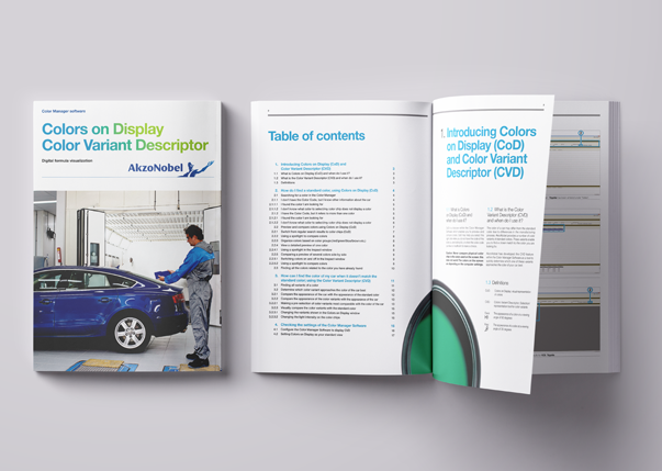 Printed software manual displayed open and closed, showing cover design, table of contents and structured layout with headings and visual elements
